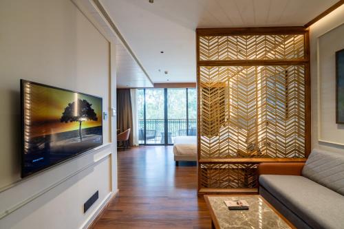 a living room with a couch and a television at Morickap Lord's 83, Trademark Collection by Wyndham in Meenangadi