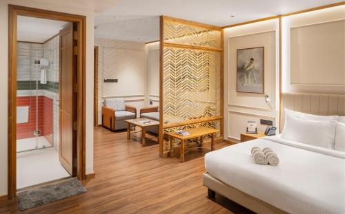 a hotel room with a bed and a bathroom at Morickap Lord's 83, Trademark Collection by Wyndham in Meenangadi