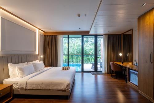 a hotel room with a bed and a desk with a desk at Morickap Lord's 83, Trademark Collection by Wyndham in Meenangadi