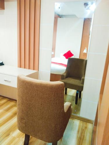 a room with a chair and a mirror at Hotel Ambrosia, Charikot, dolakha in Charikot