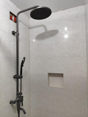 a shower with a glass door in a bathroom at RedDoorz at Pilgrims Hotel in Bulatok