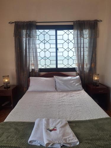 a bedroom with a large bed with a window at Japitan Waterfront Resort in Dolores