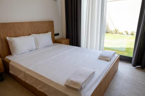 a bedroom with a large bed with two towels on it at Çeşme merkez süper lüks in Cesme