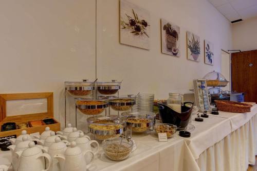 a table with tea pots and bowls on it at Sure Hotel by Best Western Ambassador Duesseldorf in Düsseldorf