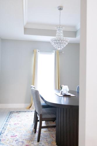 a dining room with a table and a chandelier at Sea Lion Serenity Retreat - New Construction 2024 in Port Saint Lucie
