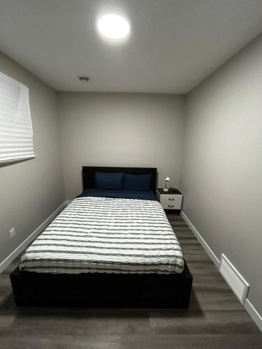 a bedroom with a large bed in a room at Entire 2 Ensuite Bedrooms in a Basement in Edmonton