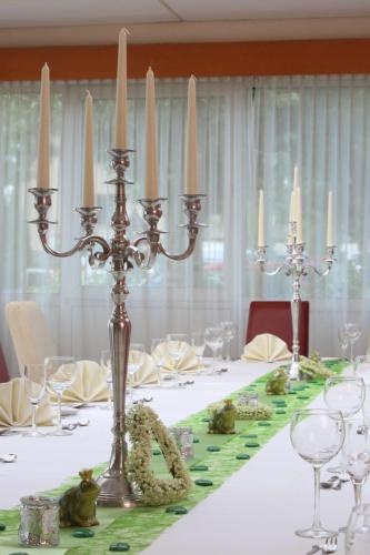 a table with a white table cloth with candles on it at Best Western Hotel Rosenau in Bad Nauheim