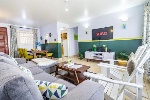 a living room with a couch and a table at Hirwado Homes & Cozy Rooms JKIA -3 Bedrooms With 5beds, 2Baths in Nairobi