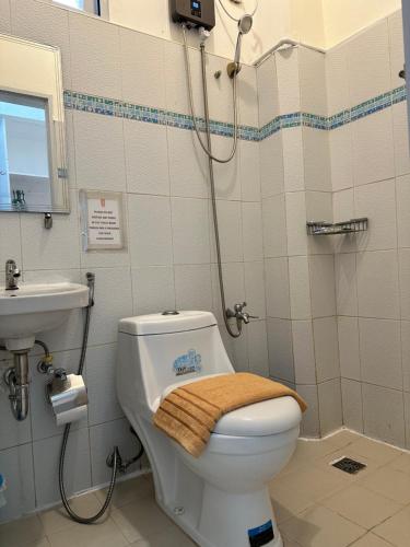 a bathroom with a toilet and a sink at Isaguirre's Pension House in Baler
