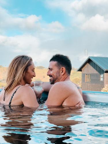 a man and a woman sitting in the water at Black Cockatoo Coorabell in Coorabell Creek