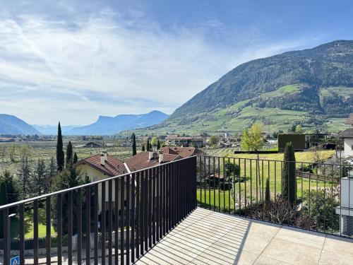 a balcony with a fence and mountains in the background at Apartsuites Rosengarten in Lagundo