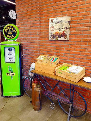 a bike parked next to a brick wall with a green machine at T11、T12 Hotel in Houli