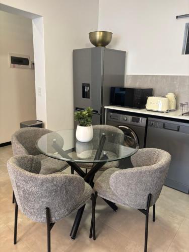 a glass table and chairs in a kitchen at Mandalay Boutique in Sandton
