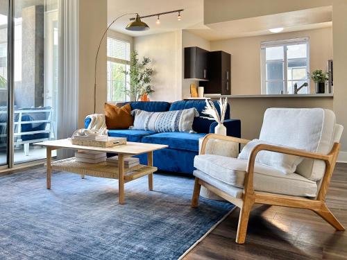 a living room with a blue couch and a table at 2BD 2BA Santa Monica Apartment with Relaxing Pool View in Los Angeles