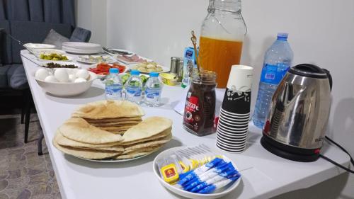 a table topped with plates of food and drinks at Downtown Inn Madaba in Madaba