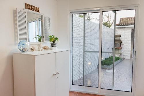 a white room with a sliding glass door at Cozy Beach House in Ribeira Grande