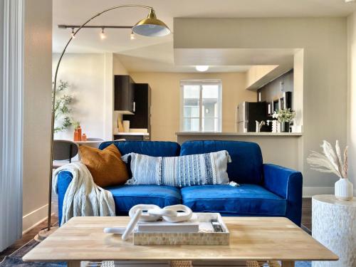 a living room with a blue couch and a table at 2BD 2BA Santa Monica Apartment with Relaxing Pool View in Los Angeles