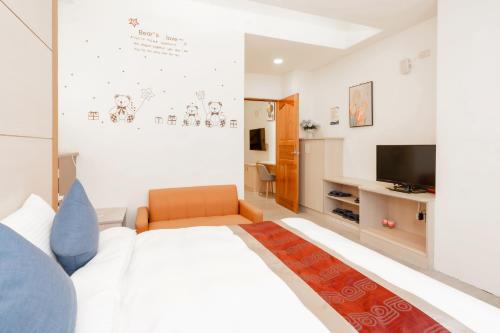 a bedroom with a large bed and a television at 飛日月漫旅Flying Sun & Moon in Yuchi