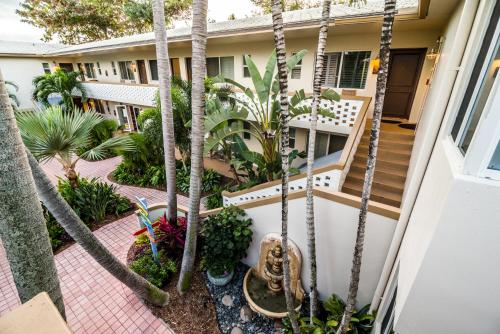 a balcony of a house with palm trees and plants at Crane's Beach House Boutique Hotel & Luxury Villas in Delray Beach