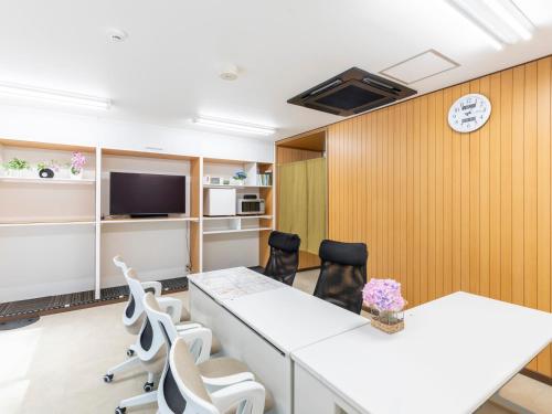 a conference room with a table and chairs at Tabist Sakuragawa River Side Hotel in Osaka