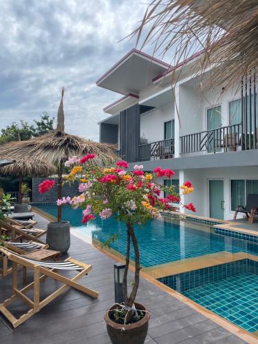a resort with a swimming pool and a building at Lanta Corsica Hotel in Ko Lanta