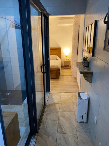 a room with a bed and a door to a bedroom at L'HORIZON F2 ti cocooon in Petite Île