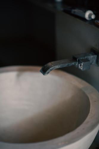 a metal wrench on top of a white toilet at Cadjan Wild Yala in Kataragama