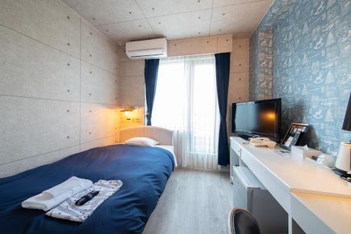 Un ou plusieurs lits dans un hébergement de l'établissement Asuka Hotel