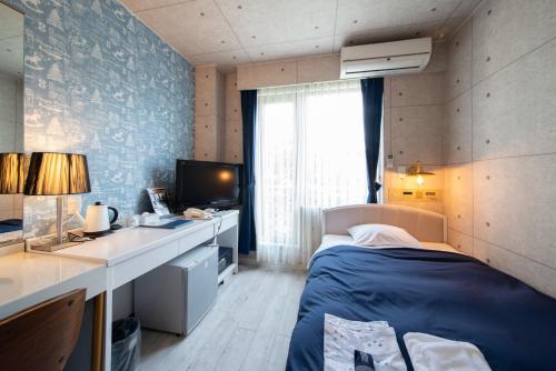 Un ou plusieurs lits dans un hébergement de l'établissement Asuka Hotel