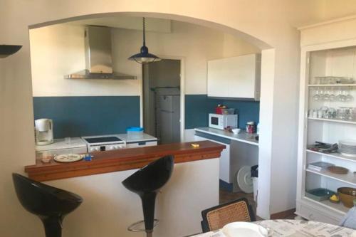 - une cuisine avec un comptoir et quelques chaises dans l'établissement Charming T3 terrace near the sea, à Saint-Cyr-sur-Mer