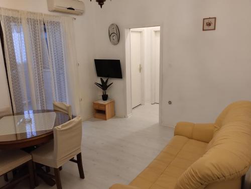 a living room with a couch and a table at Braco apartments by the sea with a sea view in Zaboric