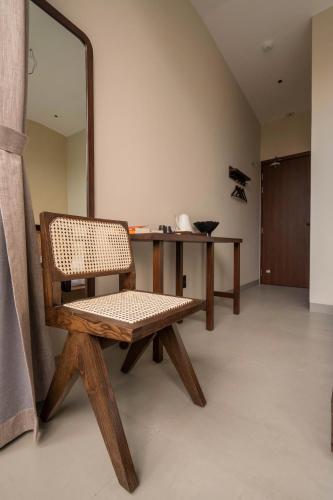 a room with a bench and a table with a mirror at Ladyfit House in Thôn Trường Giang