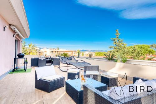 d'une terrasse avec des chaises et des tables sur un balcon. dans l'établissement Ideal two-room apartment with a large terrace and parking, à Villeneuve-Loubet