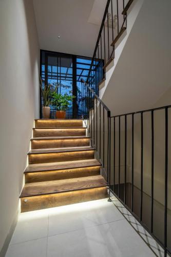 a staircase in a house with wooden steps at Ladyfit House in Thôn Trường Giang