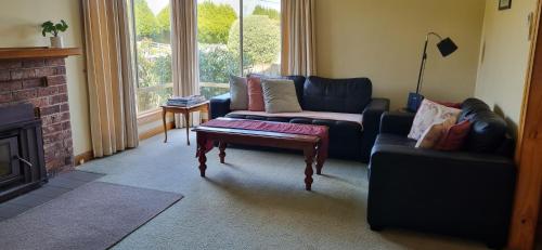 a living room with a couch and a coffee table at Belle Cottage in Scottsdale
