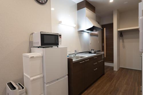 Una cocina o cocineta en Precious Hotel 綾川