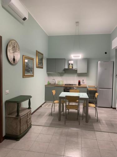 a kitchen with a table and chairs and a refrigerator at Seregno Dolce Vita in Seregno