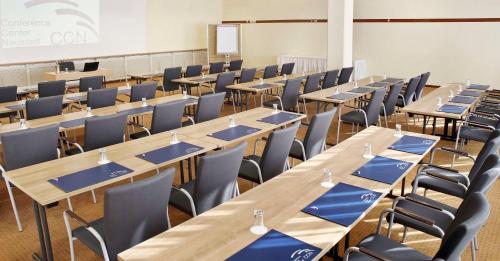 a classroom with rows of tables and chairs at Best Western Macrander Hotel Dresden in Dresden