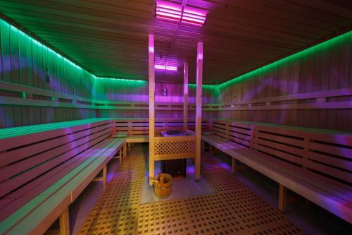 a row of benches in a room with colored lights at Hotel Bayerischer Hof Miesbach, BW Premier Collection in Miesbach