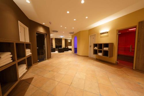 a large hallway with a large room with at Hotel Bayerischer Hof Miesbach, BW Premier Collection in Miesbach
