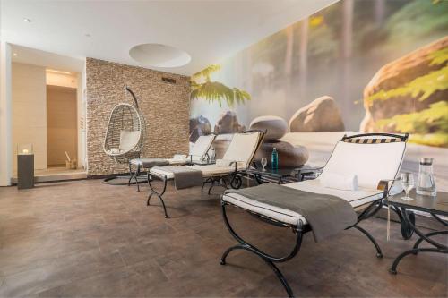 a salon with chairs and a painting on the wall at Best Western Hotel Lamm in Singen