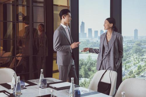 a man and a woman standing in front of a window at InterContinental Tashkent by IHG in Tashkent
