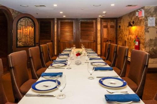 a long table with chairs and plates and wine glasses at The Peacock Inn, an Ascend Collection Hotel in Princeton
