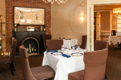 a dining room with a table and a fireplace at The Peacock Inn, an Ascend Collection Hotel in Princeton