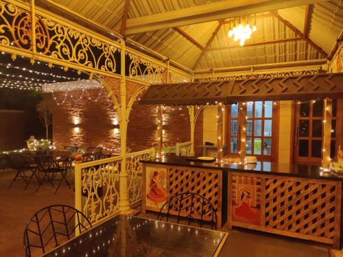 a patio with a bar and a dining area at Hotel The Balam in Jodhpur