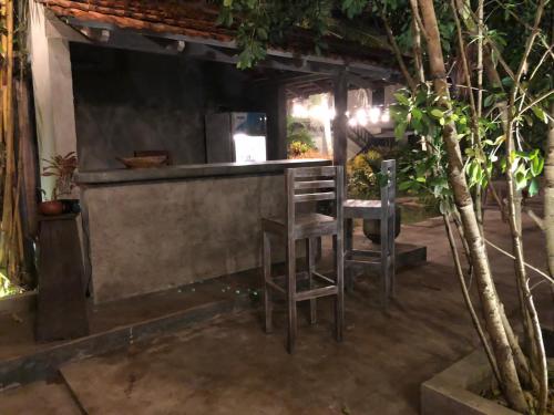 a bar with two stools sitting at a counter at Green turtle in Tangalle