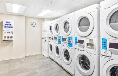 a laundry room with white washing machines in a store at Hyatt Place Houston Medical Center in Houston
