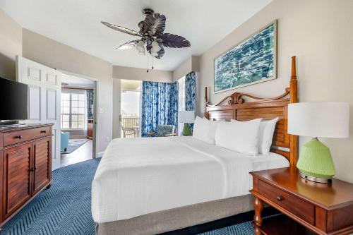 a bedroom with a large white bed and a television at Hilton Vacation Club Grande Villas Orlando in Orlando