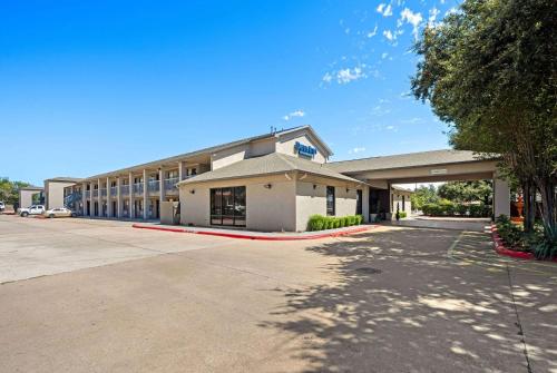 an empty parking lot in front of a building at Days Inn by Wyndham Round Rock in Round Rock