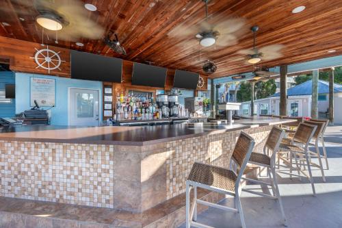 a bar with chairs in front of a counter at Hilton Vacation Club Aqua Sol Orlando West in Orlando